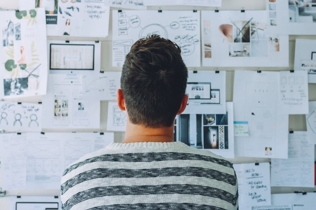 Stocksnap_Audit.jpg Homme devant un tableau blanc avec feuilles d'analyse